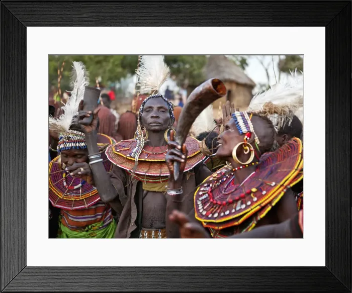 Framed Print : During a Ngetunogh ceremony, the mothers of Pokot initiates sing and dance holding high the cowhorn containers they used to smear fat over the masks of their sons as