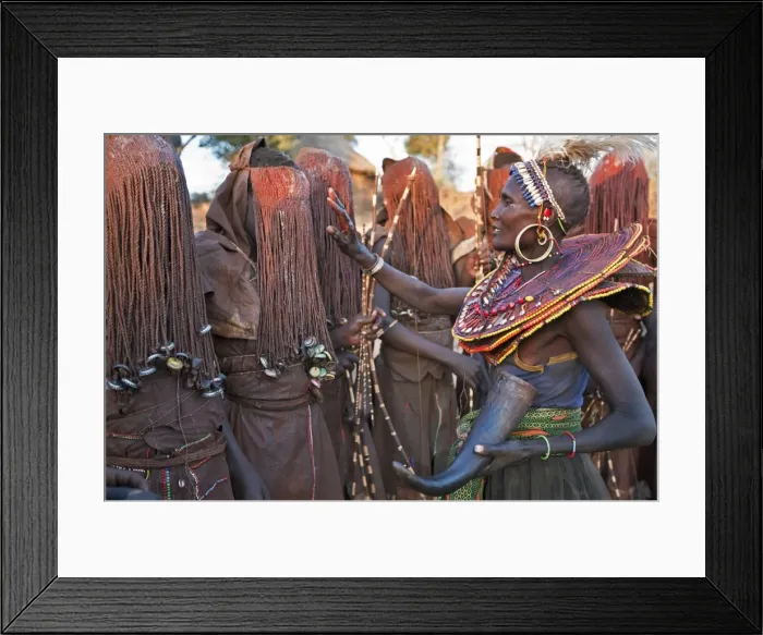 Framed Print : At the start of a Ngetunogh ceremony, the mothers of Pokot initiates will smear animal fat on the boys masks as a blessing. The boys must wear goatskins, conceal their faces with masks made from wild sisal (sansevieria) and carry bows with