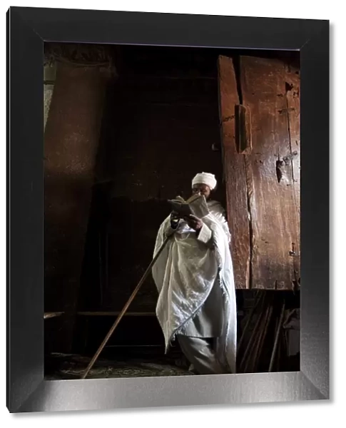 Ethiopia, Lalibela. A priest in one of the ancient rock-hewn churches of Lalibela
