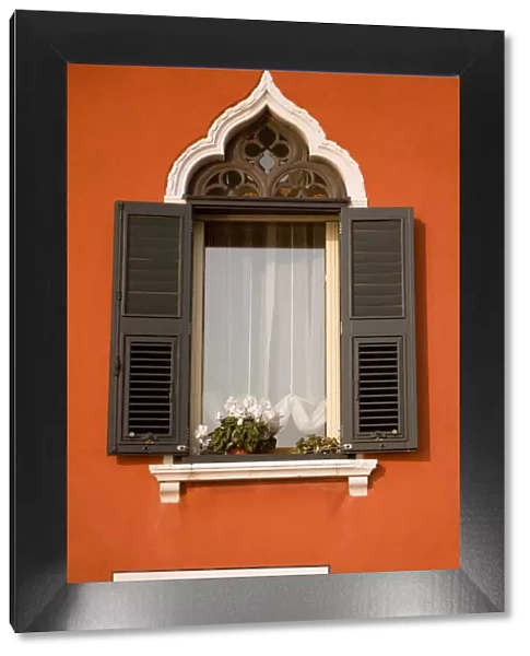Italy, Veneto, Venice; A typical Ventian window with persiane - shutters which keep out too much light while leaving the possibility to