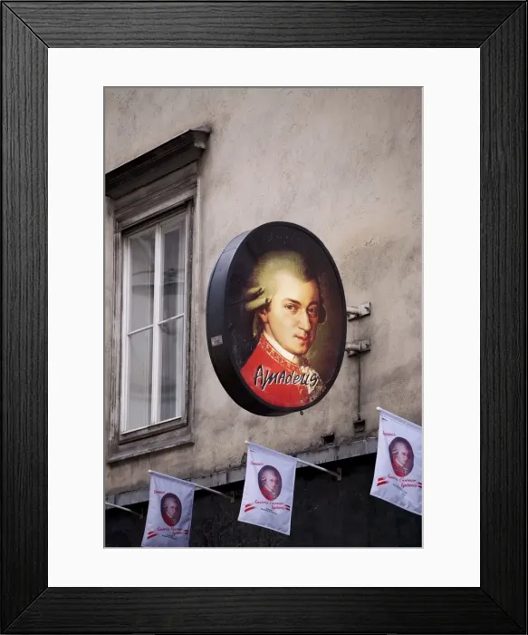 Framed Print : Vienna, Austria; An advert with the picture of famed Austrian composer Wolfgang Amadeus Mozart which serves as the picture of the famed Framed Print : Vienna, Austria; An advert with the picture of famed Austrian composer Wolfgang Amadeus Mozart which serves as the picture of the famed