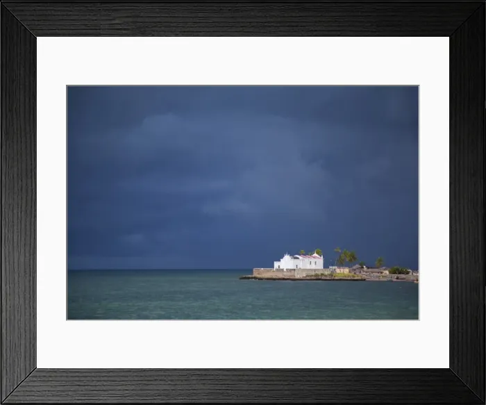 Framed Print : Mozambique, Ihla de Mozambique, Stone Town. The Church of Santo Antonio stands illuminated ahead of a dark approaching storm Framed Print : Mozambique, Ihla de Mozambique, Stone Town. The Church of Santo Antonio stands illuminated ahead of a dark approaching storm