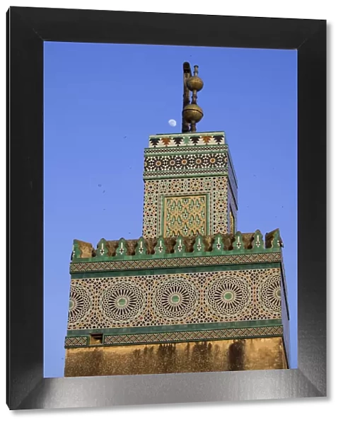 A Minaret with the early moon in the background; Old Medina in Fes, Morocco