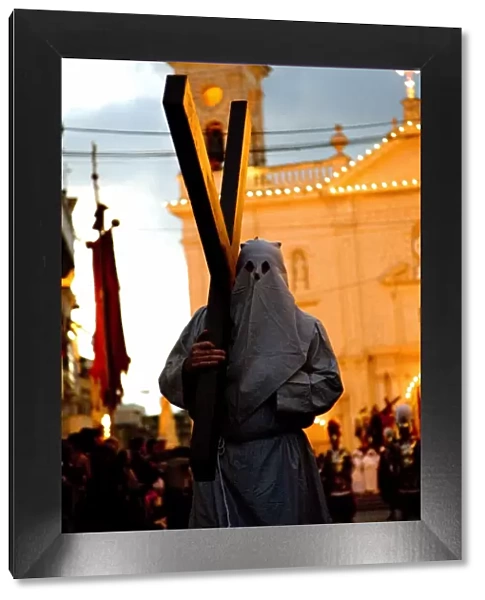 Europe, Malta, Qormi; A caped cross bearer walking barefoot during the Good Friday Processions