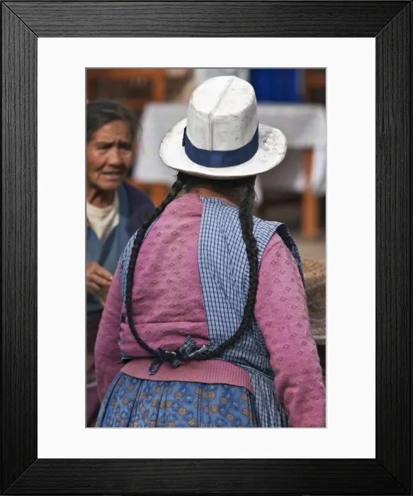Framed Print : Peru. An Indian woman with long pigtails at Pisacs busy Sunday market Framed Print : Peru. An Indian woman with long pigtails at Pisacs busy Sunday market
