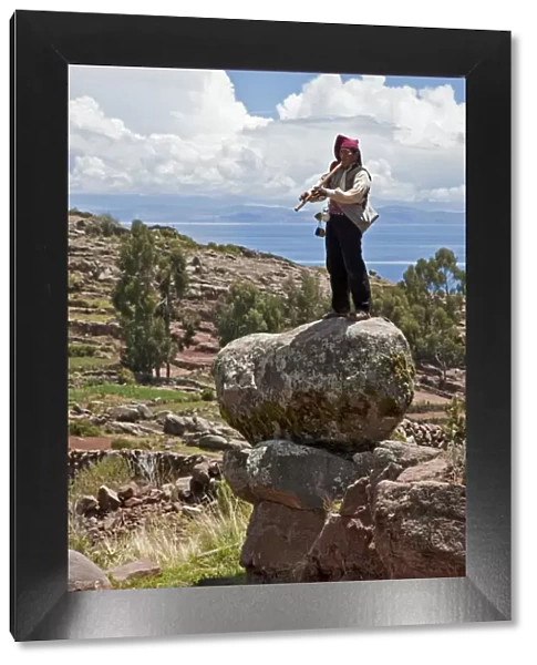 Peru, A Quechua-speaking man plays his flute on Taquile Island. The 7-sq-km island has a population of around