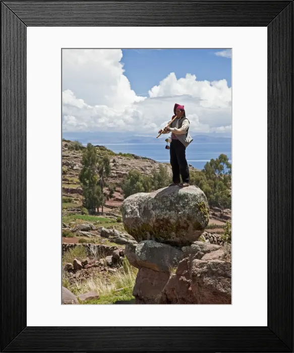 Framed Print : Peru, A Quechua-speaking man plays his flute on Taquile Island. The 7-sq-km island has a population of around