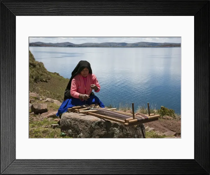 Framed Print : Peru, A Quechua-speaking woman works her traditional wooden loom on Taquile Island Framed Print : Peru, A Quechua-speaking woman works her traditional wooden loom on Taquile Island