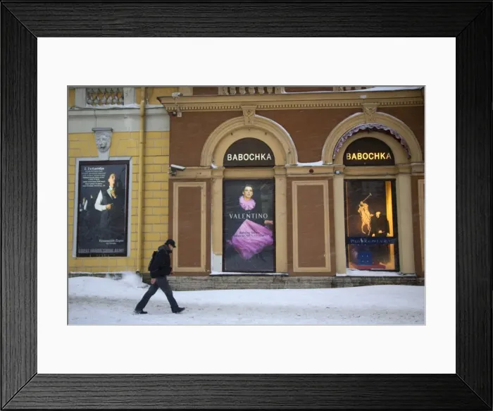 Framed Print : Russia, St. Petersburg; A man walking in front of high end clothes adverts in the city centre in Winter Framed Print : Russia, St. Petersburg; A man walking in front of high end clothes adverts in the city centre in Winter