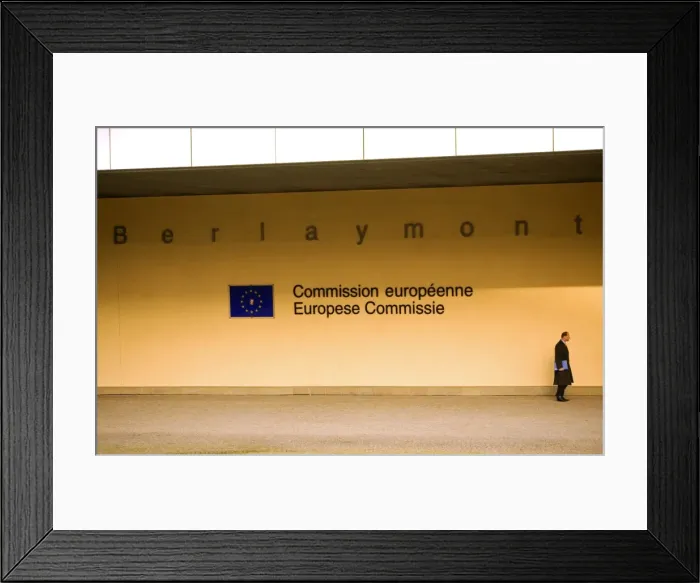 Framed Print : Belgium, Wallonia, Brussels; A beaurocrat passing in front of the European Commision Headquarters in Framed Print : Belgium, Wallonia, Brussels; A beaurocrat passing in front of the European Commision Headquarters in