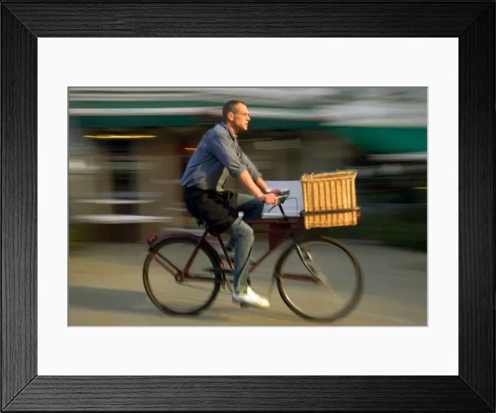 Framed Print : Belgium, Flanders, Antwerp; A man cycling, a common form of transport in the city Framed Print : Belgium, Flanders, Antwerp; A man cycling, a common form of transport in the city