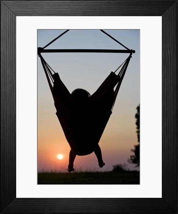 Framed Print : Malawi, Lake Malawi National Park. Young guest relaxes in a hammock at Pumulani Lodge Framed Print : Malawi, Lake Malawi National Park. Young guest relaxes in a hammock at Pumulani Lodge