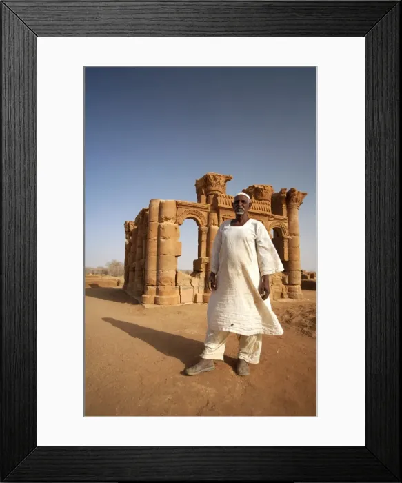Framed Print : Sudan, Nagaa. The solitary guide at the remote ruins of Nagaa stands in front of the ruins Framed Print : Sudan, Nagaa. The solitary guide at the remote ruins of Nagaa stands in front of the ruins