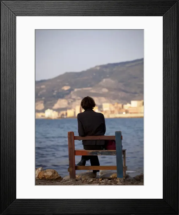 Framed Print : Sicily, Italy, Western Europe; A person sitting on a bench facing the fishing port of Trapani Framed Print : Sicily, Italy, Western Europe; A person sitting on a bench facing the fishing port of Trapani