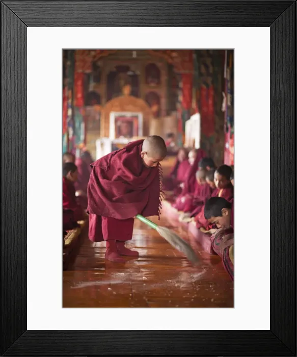 Framed Print : India, Ladakh, Thiksey. Young novice monk sweeping up the tsampa crumbs at morning prayers or puja Framed Print : India, Ladakh, Thiksey. Young novice monk sweeping up the tsampa crumbs at morning prayers or puja