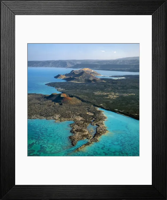 Framed Print : An aerial view of the volcanic cones at the inlet of Ghoubbet el Kharb (the Devils Throat), a region of high seismic activity where deep fractures in the lava continue to widen year by year Framed Print : An aerial view of the volcanic cones at the inlet of Ghoubbet el Kharb (the Devils Throat), a region of high seismic activity where deep fractures in the lava continue to widen year by year