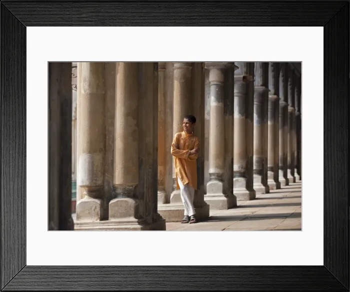 Framed Print : A student relaxes beside the pillars of the impressive Hugli Imambara building which was built in 1858 and is used as a school Framed Print : A student relaxes beside the pillars of the impressive Hugli Imambara building which was built in 1858 and is used as a school
