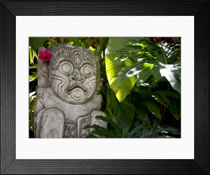 Framed Print : Bali, Ubud. A stone carving, adorned with a hibiscus flower, sits in tropical gardens Framed Print : Bali, Ubud. A stone carving, adorned with a hibiscus flower, sits in tropical gardens