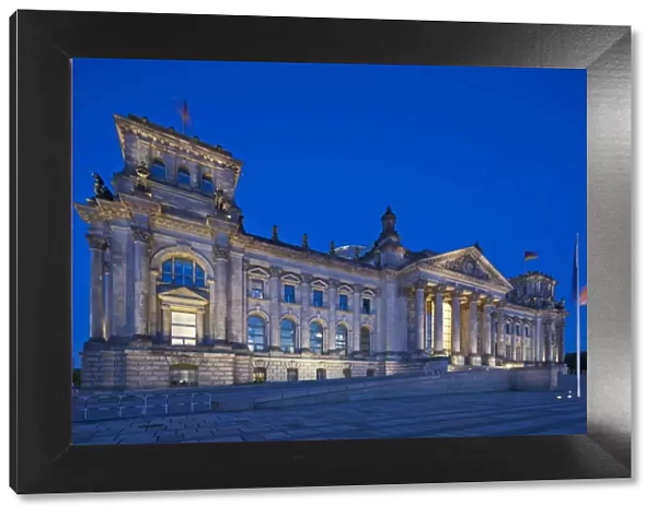 Twilight view of the front facade of the Reichstag building in Tiergarten