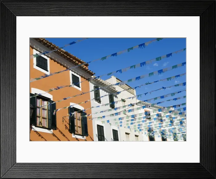 Framed Print : Spain, Menorca. Bunting over a street in Es Mercadal