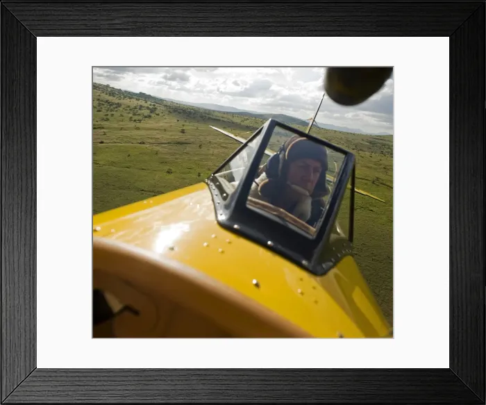 Framed Print : Kenya, Laikipia, Lewa Downs. Will Craig flies his 1930s style Waco Classic open cockpit bi-plane for ultimate Framed Print : Kenya, Laikipia, Lewa Downs. Will Craig flies his 1930s style Waco Classic open cockpit bi-plane for ultimate