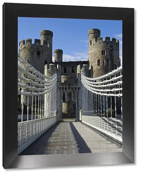 UK, North Wales; Conwy. The elegant Suspension Bridge built by Thomas Telford across the Conwy River to the imposing
