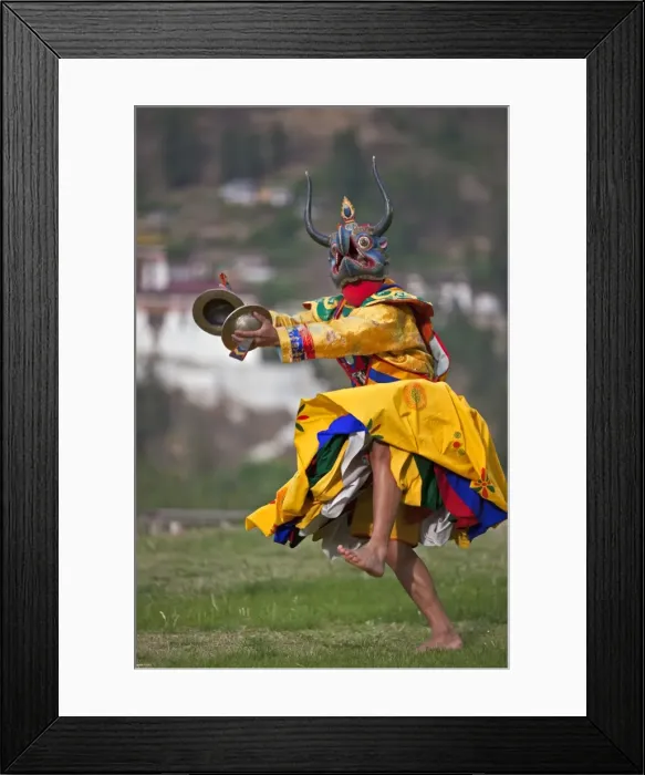 Framed Print : A masked dancer with cymbals performs Drametse Nga Cham (the religious masked dance) Framed Print : A masked dancer with cymbals performs Drametse Nga Cham (the religious masked dance)