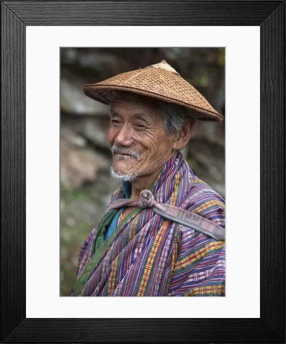 Framed Print : A wizened old farmer near Mongar wears the traditional knee-length national robe called gho Framed Print : A wizened old farmer near Mongar wears the traditional knee-length national robe called gho