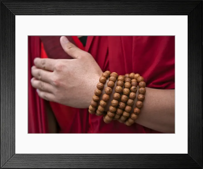 Framed Print : Prayer beads wrapped round the wrist of a red-robed monk near Mongar. There is a special religious significance in having exactly 108 beads in Framed Print : Prayer beads wrapped round the wrist of a red-robed monk near Mongar. There is a special religious significance in having exactly 108 beads in