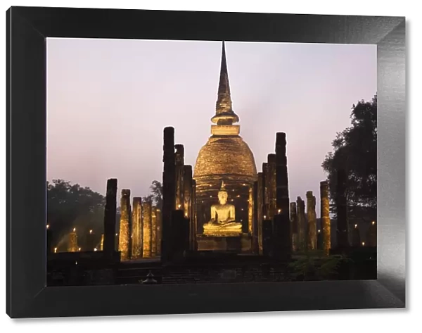 Thailand, Sukhothai, Sukhothai. Ruins of Wat Sa Si (also known as Sacred Pond Monastery) lit during the festival of Loy Krathong in the Sukhothai
