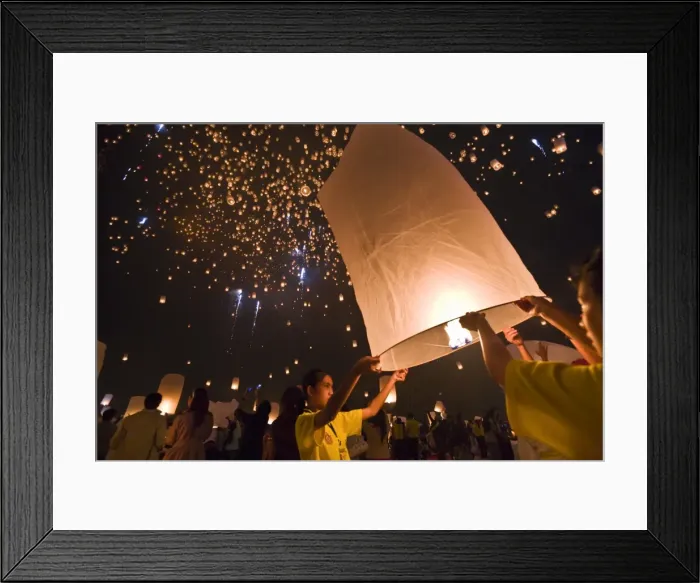 Framed Print : Thailand, Chiang Mai, San Sai. Revellers launch khom loi (sky lanterns) into the night sky during the Yi Peng festival. The ceremony is a Lanna (northern Thailand) tradition and coincides with Loy Krathong festivities. The khom loi are Framed Print : Thailand, Chiang Mai, San Sai. Revellers launch khom loi (sky lanterns) into the night sky during the Yi Peng festival. The ceremony is a Lanna (northern Thailand) tradition and coincides with Loy Krathong festivities. The khom loi are