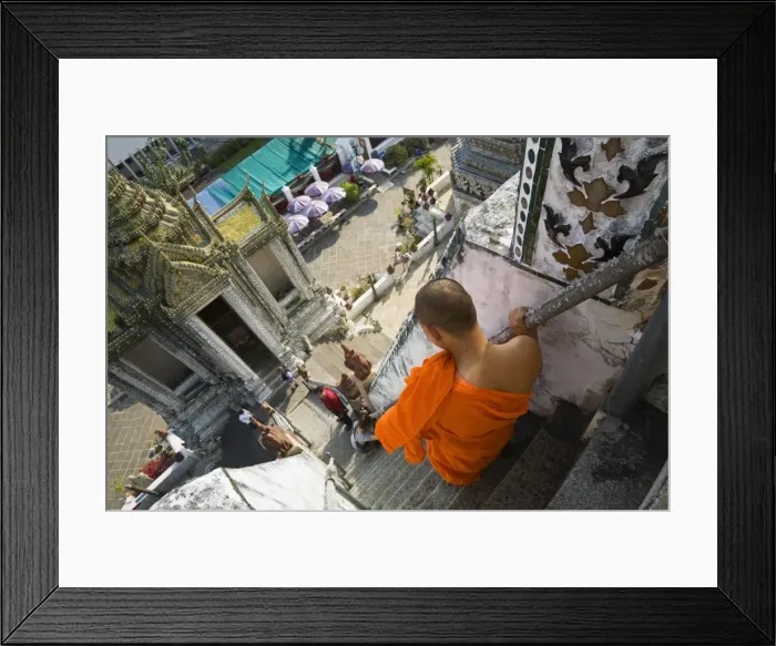 Framed Print : Thailand, Bangkok. A monk descends the steps of the prang (Khmer-style tower) at Wat Arun Framed Print : Thailand, Bangkok. A monk descends the steps of the prang (Khmer-style tower) at Wat Arun