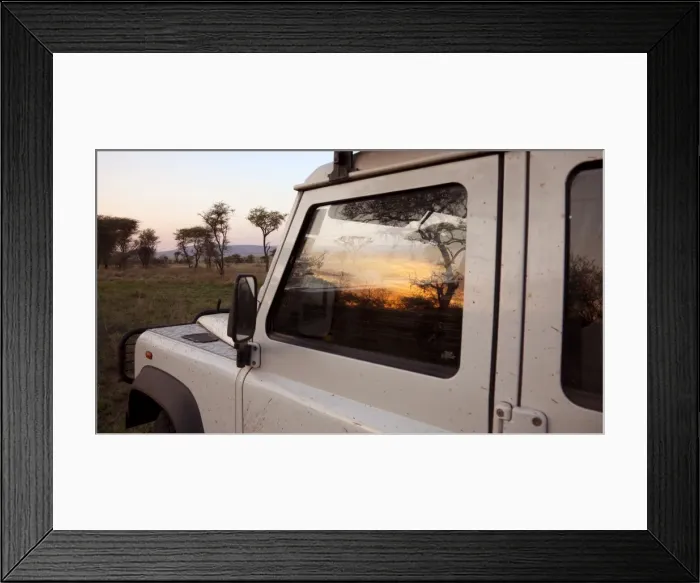 Framed Print : Tanzania, Serengeti. Sunrise over the bush is reflected in the window of a Land Rover Framed Print : Tanzania, Serengeti. Sunrise over the bush is reflected in the window of a Land Rover