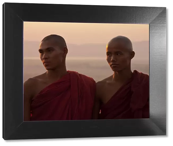 Myanmar, Burma, Mandalay. Monks enjoying the evening light, Mandalay Hill