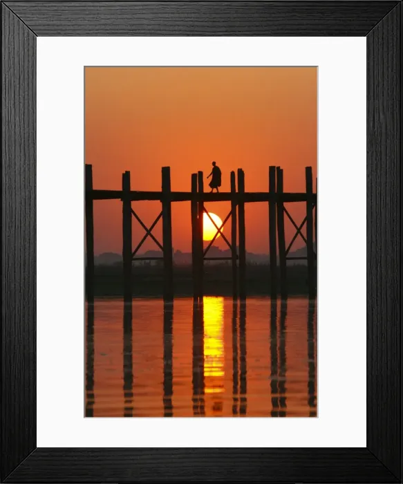 Framed Print : Myanmar (Burma), Amarapura, Taungthaman Lake, U Beins Bridge. A monk walking home at sunset over U Beins Bridge, over 200 years old and the worlds longest Framed Print : Myanmar (Burma), Amarapura, Taungthaman Lake, U Beins Bridge. A monk walking home at sunset over U Beins Bridge, over 200 years old and the worlds longest