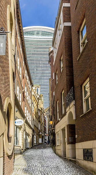 20 Fenchurch Street Building, also known as the Walkie talkie, through a cobbled alleyway
