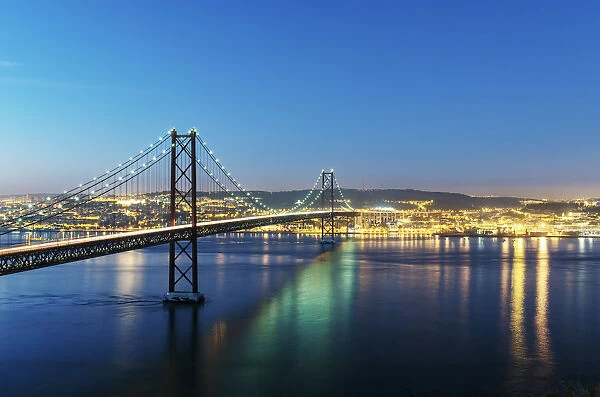 25th of April Bridge over the Tagus river (Tejo river) and Lisbon at twilight. Portugal