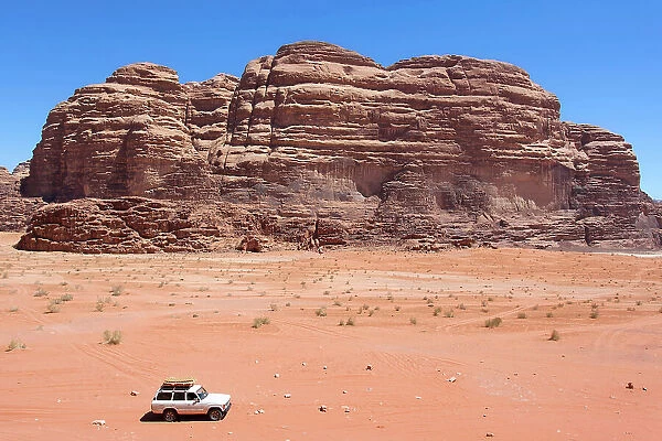 A 4x4 off-road vehicle car in the Wadi Rum desert, Aqaba, Jordan, Middle East. Declared a UNESCO World Heritage Site since 2011