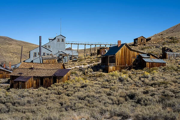 Abandoned wooden structures in Bodie ghost town against clear sky, Mono County