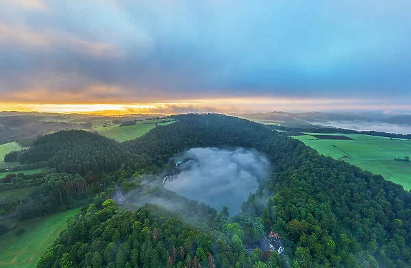 Aerail view at Gemuendener Maar at sunrise, Eifel, Rhineland-Palatinate, Germany