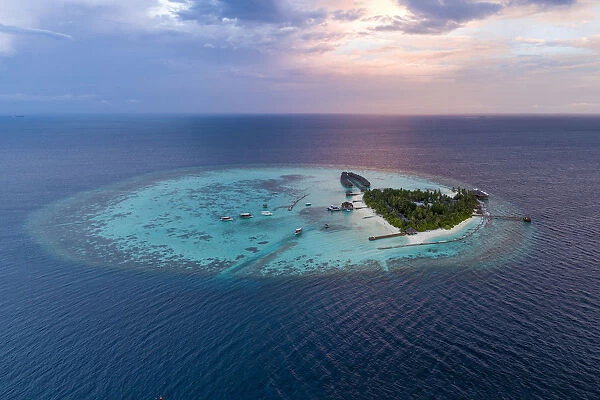 Aerial drone view of a tropical island at sunset, Maldives