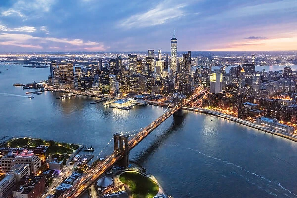 Aerial of lower Manhattan skyline and Brooklyn bridge at dusk, New York, USA