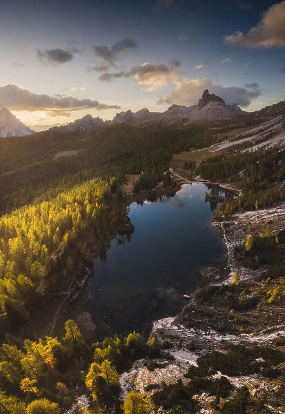 Aerial panoramic view of the Federa lake, one of the most incredible locations of the area to capture the larches typical autumn colors, with the Becco di Mezzodi mountain in the background. Dolomites, Italy