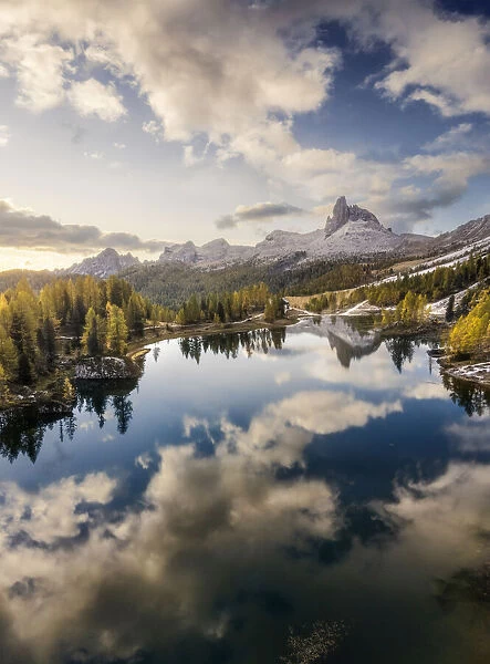 Aerial panoramic view of the Federa lake, one of the most incredible locations of the area to capture the larches typical autumn colors, with the Becco di Mezzodi mountain in the background. Dolomites, Italy