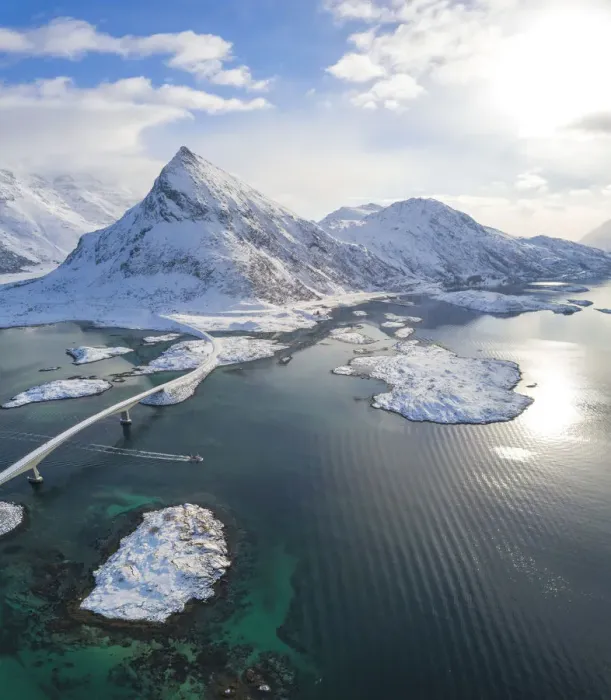 Framed Print : Aerial panoramic view of snowy peak of Volanstinden and Fredvang bridge, Lofoten Islands Framed Print : Aerial panoramic view of snowy peak of Volanstinden and Fredvang bridge, Lofoten Islands
