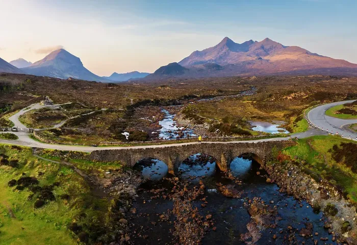 Framed Print : Aerial and panoramic view of a tourist on Sligachan Old Bridge observes Black Cuillin at sunrise, Isle of Skye, Inner Hebrides, Trotternish peninsula, Highlands, Scotland, United Kingdom (MR) Framed Print : Aerial and panoramic view of a tourist on Sligachan Old Bridge observes Black Cuillin at sunrise, Isle of Skye, Inner Hebrides, Trotternish peninsula, Highlands, Scotland, United Kingdom (MR)
