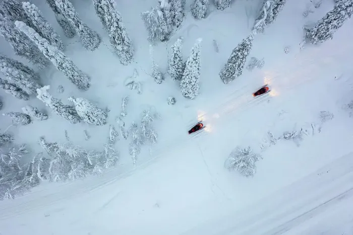 Framed Print : Aerial of snowmobiles on road through snow-covered forest, Kuusamo, Finland Framed Print : Aerial of snowmobiles on road through snow-covered forest, Kuusamo, Finland