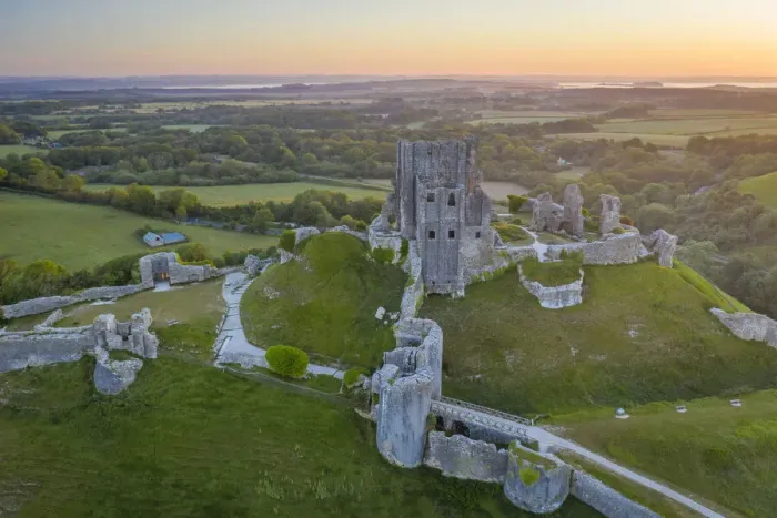 Framed Print : Aerial view of the abandoned ruins of Corfe Castle at dawn, Dorset, England Framed Print : Aerial view of the abandoned ruins of Corfe Castle at dawn, Dorset, England