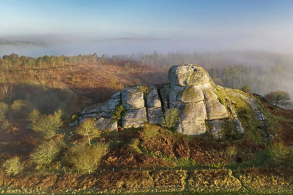 Aerial view of Blackingstone Rock on a misty winter morning, Dartmoor National Park, Devon, England. Winter (March) 2022