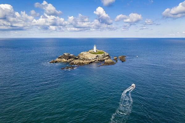 Aerial view of boat approaching Godrevy lighthouse and island, St Ives Bay, Cornwall